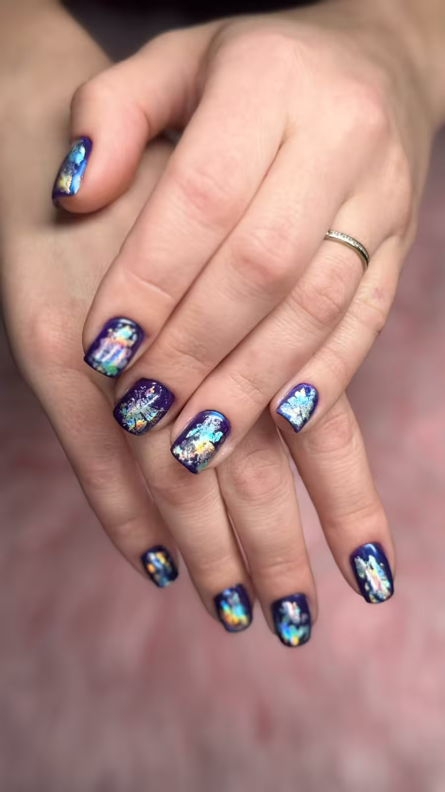 Dark blue nails with mystical foil design and gloss effect
